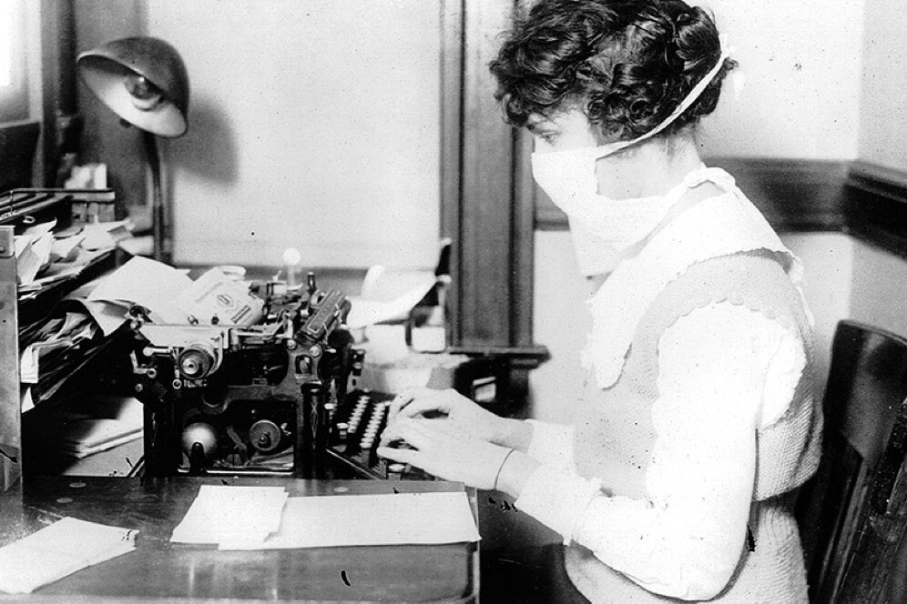 woman typing in mask